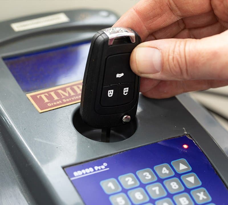 Car key being programmed on-site by AW Auto Locks in Essex
